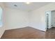 Bright bedroom with hardwood floors and door to bathroom at 7933 Grey Teal St, North Las Vegas, NV 89084