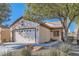 Single-story home with a two-car garage and landscaped yard at 7933 Grey Teal St, North Las Vegas, NV 89084