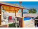 Relaxing backyard with pool, spa, and covered patio with bar at 8113 Hercules Dr, Las Vegas, NV 89128