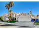 House exterior with a two-car garage and palm trees at 8113 Hercules Dr, Las Vegas, NV 89128