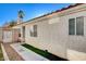 Back exterior of house with walkway and landscaping at 8113 Hercules Dr, Las Vegas, NV 89128