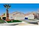 Front view of a house with a two-car garage and palm trees at 8113 Hercules Dr, Las Vegas, NV 89128