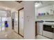 Hallway with mirrored closet and view into laundry room at 8113 Hercules Dr, Las Vegas, NV 89128