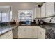 L-shaped kitchen with granite countertops and white cabinets at 8113 Hercules Dr, Las Vegas, NV 89128