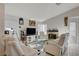 Bright living room with white sofas, fireplace, and TV at 8113 Hercules Dr, Las Vegas, NV 89128