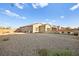 Large gravel backyard with partial view of house and patio furniture at 8535 Black Brush Ln, Las Vegas, NV 89131