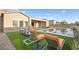 Relaxing backyard with pool, patio furniture, and artificial turf at 8535 Black Brush Ln, Las Vegas, NV 89131