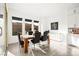 Bright dining area with a wooden table and six black velvet chairs at 8535 Black Brush Ln, Las Vegas, NV 89131