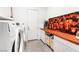 Modern laundry room, wood countertop, and decorative backsplash at 8535 Black Brush Ln, Las Vegas, NV 89131