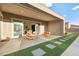 Covered patio features modern furniture and grassy area at 8535 Black Brush Ln, Las Vegas, NV 89131