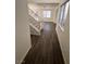 Spacious entryway with dark laminate flooring and a wooden staircase at 8553 Last Point Ave, Las Vegas, NV 89129