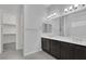 Double vanity bathroom with dark brown cabinets at 87 Newton Ridge Way, Las Vegas, NV 89183