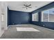 Bedroom with navy blue walls and carpet flooring at 87 Newton Ridge Way, Las Vegas, NV 89183