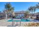 Community pool with tables and chairs for relaxation at 87 Newton Ridge Way, Las Vegas, NV 89183