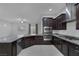 Spacious kitchen featuring granite countertops and dark wood cabinets at 87 Newton Ridge Way, Las Vegas, NV 89183