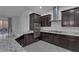 Modern kitchen with dark cabinets, granite countertops and stainless steel appliances at 87 Newton Ridge Way, Las Vegas, NV 89183