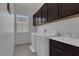 Bright laundry room, with washer, dryer and cabinets at 87 Newton Ridge Way, Las Vegas, NV 89183