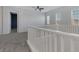 Spacious loft area with a white railing and carpet at 87 Newton Ridge Way, Las Vegas, NV 89183