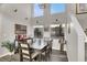 Dining room with a large table, six chairs, and high ceilings at 8753 Arawana Pl, Henderson, NV 89074