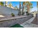 Landscaped side yard with walkway and retaining wall at 8753 Arawana Pl, Henderson, NV 89074