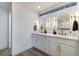 Elegant bathroom with double vanity, marble tile and modern lighting at 9 White Tail Ct, Henderson, NV 89074