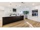 Modern kitchen with white cabinets, marble countertops, and a large island at 9 White Tail Ct, Henderson, NV 89074