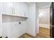 Clean laundry room with white cabinets and extra storage space at 9 White Tail Ct, Henderson, NV 89074