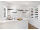 Modern wet bar with white quartz countertops and wine storage at 9 White Tail Ct, Henderson, NV 89074