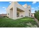 Modern home with grassy backyard and covered patio at 9780 Solar Ave, Las Vegas, NV 89149