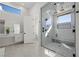 Modern bathroom with a spacious walk-in shower and marble tile at 9780 Solar Ave, Las Vegas, NV 89149