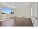 Bedroom with hardwood floors, large window with mountain views, and ceiling fan at 9780 Solar Ave, Las Vegas, NV 89149