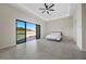 Bedroom with gray tile floors, a bed, and sliding glass doors to the backyard at 9780 Solar Ave, Las Vegas, NV 89149