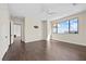 Bedroom with hardwood floors, large window, and access to another room at 9780 Solar Ave, Las Vegas, NV 89149