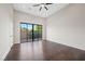 Bright bedroom with hardwood floors and sliding glass doors leading to backyard at 9780 Solar Ave, Las Vegas, NV 89149