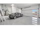 Finished garage with epoxy floor and Tesla at 9780 Solar Ave, Las Vegas, NV 89149