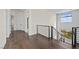 Elegant hallway with hardwood floors and modern metal railing staircase at 9780 Solar Ave, Las Vegas, NV 89149