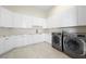 Laundry room with modern cabinetry, marble countertops, and LG washer/dryer at 9780 Solar Ave, Las Vegas, NV 89149