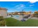 Spacious backyard with a refreshing pool, lush grass, and patio furniture at 1024 San Eduardo Ave, Henderson, NV 89002