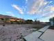 Vast backyard with desert landscaping and distant mountain views at 1032 Morning Sun Way, Las Vegas, NV 89110