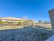 Large backyard with gravel landscaping, concrete path, and mountain views at 1032 Morning Sun Way, Las Vegas, NV 89110