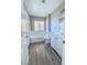 Updated bathroom, featuring a bathtub, toilet and white vanity at 1032 Morning Sun Way, Las Vegas, NV 89110