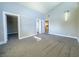 Primary bedroom with grey carpet, access to closet and bathroom at 1032 Morning Sun Way, Las Vegas, NV 89110