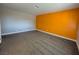 Bedroom with gray carpet and an orange accent wall at 1032 Morning Sun Way, Las Vegas, NV 89110