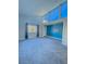 Bedroom with wall-to-wall windows and blue accent wall at 1032 Morning Sun Way, Las Vegas, NV 89110