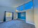 Bedroom with wall-to-wall windows and blue accent wall at 1032 Morning Sun Way, Las Vegas, NV 89110