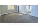 Grey carpeted bedroom with window and access to bathroom at 1032 Morning Sun Way, Las Vegas, NV 89110