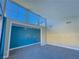 Bedroom with wall-to-wall windows and blue accent wall at 1032 Morning Sun Way, Las Vegas, NV 89110