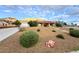 Single story home with red tile roof, desert landscaping, and mountain views at 1032 Morning Sun Way, Las Vegas, NV 89110
