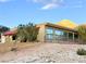 Tan house with large windows and a mountain backdrop at 1032 Morning Sun Way, Las Vegas, NV 89110