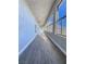 Long hallway with light hardwood floors and large windows at 1032 Morning Sun Way, Las Vegas, NV 89110